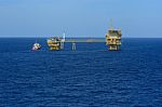 The Offshore Oil Rig And Supply Boat Stock Photo