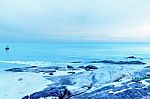 The Sand Beach And Sea With Fishing Boat That Parked On The Beachfront With Rock And Reef In Morning With Sunrise Stock Photo