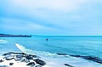 The View Of The Sand Beach And Sea Wave With Rock And Reef On Morning With Sunrise Stock Photo