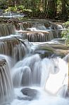 The Water Flowing Over Rocks And Trees Down A Waterfall At Huay Mae Khamin Waterfall National Park ,kanchana Buri In Thailand Stock Photo