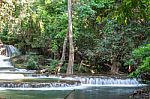 The Water Flowing Over Rocks And Trees Down A Waterfall At Huay Mae Khamin Waterfall National Park ,kanchana Buri In Thailand Stock Photo