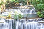 The Water Flowing Over Rocks And Trees Down A Waterfall At Huay Mae Khamin Waterfall National Park ,kanchana Buri In Thailand Stock Photo