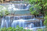 The Water Flowing Over Rocks And Trees Down A Waterfall At Huay Mae Khamin Waterfall National Park ,kanchana Buri In Thailand Stock Photo