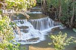 The Water Flowing Over Rocks And Trees Down A Waterfall At Huay Mae Khamin Waterfall National Park ,kanchana Buri In Thailand Stock Photo