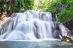 The Water Flowing Over Rocks And Trees Down A Waterfall At Huay Mae Khamin Waterfall National Park ,kanchana Buri In Thailand Stock Photo