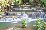 The Water Flowing Over Rocks And Trees Down A Waterfall At Huay Mae Khamin Waterfall National Park ,kanchana Buri In Thailand Stock Photo