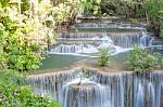 The Water Flowing Over Rocks And Trees Down A Waterfall At Huay Mae Khamin Waterfall National Park ,kanchana Buri In Thailand Stock Photo