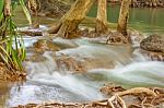 The Water Flowing Over Rocks And Trees Down A Waterfall At Huay Mae Khamin Waterfall National Park ,kanchana Buri In Thailand Stock Photo