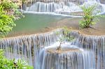 The Water Flowing Over Rocks And Trees Down A Waterfall At Huay Mae Khamin Waterfall National Park ,kanchana Buri In Thailand Stock Photo