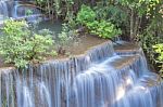 The Water Flowing Over Rocks And Trees Down A Waterfall At Huay Mae Khamin Waterfall National Park ,kanchana Buri In Thailand Stock Photo