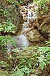 The Water Flowing Over Rocks And Trees Down A Waterfall At Huay Mae Khamin Waterfall National Park ,kanchana Buri In Thailand Stock Photo