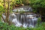 The Water Flowing Over Rocks And Trees Down A Waterfall At Huay Mae Khamin Waterfall National Park ,kanchana Buri In Thailand Stock Photo