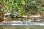 The Water Flowing Over Rocks And Trees Down A Waterfall At Huay Mae Khamin Waterfall National Park ,kanchana Buri In Thailand Stock Photo