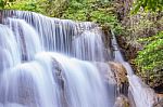 The Water Flowing Over Rocks And Trees Down A Waterfall At Huay Mae Khamin Waterfall National Park ,kanchana Buri In Thailand Stock Photo