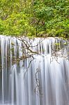 The Water Flowing Over Rocks And Trees Down A Waterfall At Huay Mae Khamin Waterfall National Park ,kanchana Buri In Thailand Stock Photo