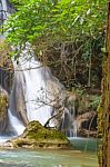 The Water Flowing Over Rocks And Trees Down A Waterfall At Huay Mae Khamin Waterfall National Park ,kanchana Buri In Thailand Stock Photo