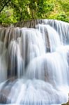 The Water Flowing Over Rocks And Trees Down A Waterfall At Huay Mae Khamin Waterfall National Park ,kanchana Buri In Thailand Stock Photo