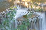 The Water Flowing Over Rocks And Trees Down A Waterfall At Huay Mae Khamin Waterfall National Park ,kanchana Buri In Thailand Stock Photo