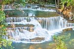 The Water Flowing Over Rocks And Trees Down A Waterfall At Huay Mae Khamin Waterfall National Park ,kanchana Buri In Thailand Stock Photo