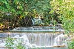 The Water Flowing Over Rocks And Trees Down A Waterfall At Huay Mae Khamin Waterfall National Park ,kanchana Buri In Thailand Stock Photo