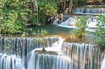 The Water Flowing Over Rocks And Trees Down A Waterfall At Huay Mae Khamin Waterfall National Park ,kanchana Buri In Thailand Stock Photo