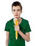 Thinking School Boy Holding Pencil Stock Photo