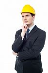 Thoughtful Architect Wearing A Hard Hat Stock Photo