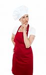 Thoughtful Female Chef Standing Stock Photo