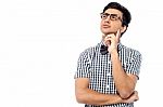 Thoughtful Young Man Looking Up Stock Photo