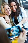 Three Friends Taking Photos With A Smartphone Stock Photo