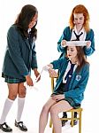 Three Girls Learning First Aid Bandaging Wrapping At School, Wearing Green School Uniform Stock Photo