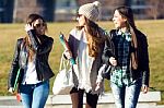 Three Students Girls Walking In The Campus Of University Stock Photo