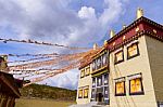 Tibetan Temple, Brick Wall Structure And Prayer Flags In Shangri Stock Photo