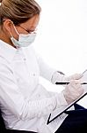 Top View Of Doctor With Writing Pad And Mask Stock Photo