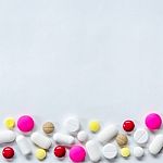 Top View Of The Pills On The White Background, The Drug And Capsule Pills On The Floor Stock Photo