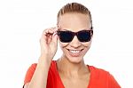 Trendy Woman Adjusting Her Sunglasses Stock Photo