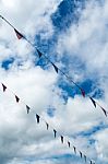 Triangle Flag Hanging On The Rope And Blue Sky Stock Photo