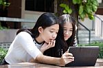 Two Asia Thai High School Student Best Friends Beautiful Girl Using Her Tablet And Funny Stock Photo