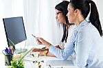 Two Business Woman Working In Office With Computer Stock Photo