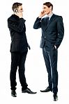 Two Businessmen Talking On Cellphone Stock Photo