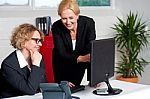 Two Cheerful Corporate Women In Office Stock Photo