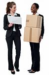 Two Female Workers Discussing Stock Details Stock Photo