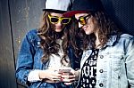 Two Girls Having Fun With Smartphones Stock Photo