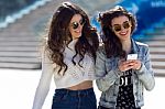 Two Girls Having Fun With Smartphones Stock Photo