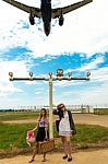 Two Girls Hitchhiking A Plane Stock Photo