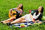 Two Girls With Guitar During Picnic Stock Photo