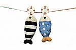 Two Pillows Fish Shape Hanging On The Rope Isolated On White Background Stock Photo