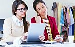 Two Young Businesswomen Working With Digital Tablet In Her Offic Stock Photo