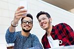 Two Young Entrepreneurs Taking A Selfie At Coffee Shop Stock Photo