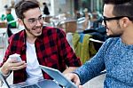 Two Young Entrepreneurs Working At Coffee Shop Stock Photo